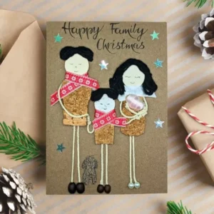 Unique Handmade Personalised Family Christmas Card Unique handmade personalised family Christmas card featuring a family crafted from cork and coffee beans, with a dog and calligraphy text.
