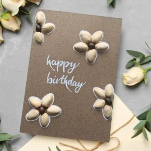 Unique Handmade Pistachio Shell Flower Birthday Card Unique Handmade Pistachio Shell Flower Birthday Card with 4 flowers made of pistachio shells with Happy Birthday text in the middle.