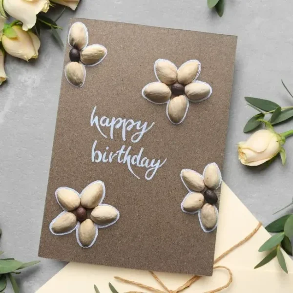 Unique Handmade Pistachio Shell Flower Birthday Card with 4 flowers made of pistachio shells with Happy Birthday text in the middle.