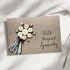 Unique Handmade Sympathy Card made of buttons and string on brown paper.