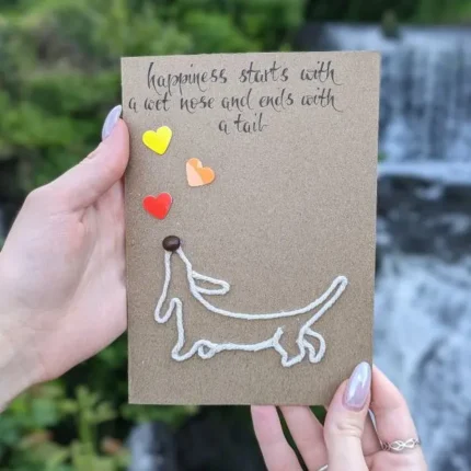 Best Handmade Birthday Card with Dachshund for Dog Lovers with a yarn outline of a Dachshund and three heart embellishments.