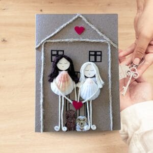 Handmade new home card illustrating two women with a house and key, representing the excitement of a new home and shared experiences.