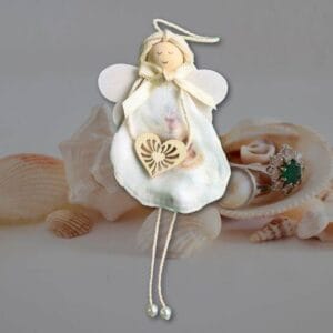 White angel sculpture made of seashell featuring a heart, part of the Handmade Shell Angels collection.