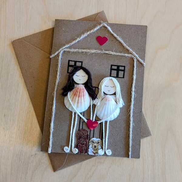 Personalised new home card with two figures made from seashells, twine, and a pink heart 2.