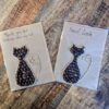 Handmade cat greeting cards made with coffee beans and jute string on kraft paper, featuring ‘Thank you for looking after my cat’ and ‘Good Luck’ messages.