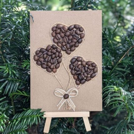 Handmade Valentines card showcasing coffee beans in a heart shape on a small easel.
