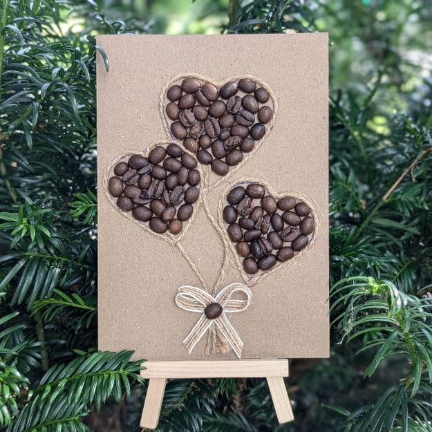 Handmade Valentines card showcasing coffee beans in a heart shape on a small easel.