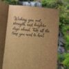 Inside of a handmade get well soon card featuring a handwritten message wishing rest, strength, and healing, written on kraft paper.