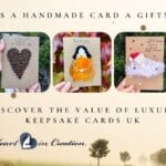 Three handmade luxury keepsake cards displayed against a nature backdrop, featuring unique designs like a coffee bean heart, a dried leaf figure, and a feathered baby’s first Christmas card by Heart in Creation.