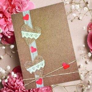 Handmade Burlap Hearts Valentine’s Card with Delicate Lace 1 Handmade Burlap Hearts Valentine’s Card with Delicate Lace - Close-up of the tactile burlap texture and delicate lace detail on a handmade greeting.
