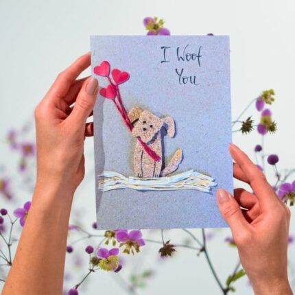Handmade Dog Mum Valentines Card displayed with a rustic brown recycled envelope on a floral background.