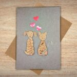 Handmade Dog and Cat Valentines Card - Rustic cork silhouettes of a dog and cat with three red hearts on recycled brown cardstock.