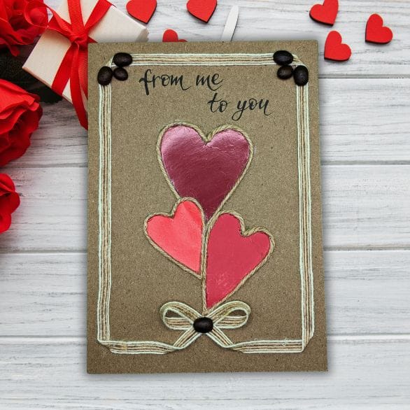 Handmade Valentine’s Day card featuring layered paper hearts and cotton string on kraft card, unique romantic greeting card for her or him.