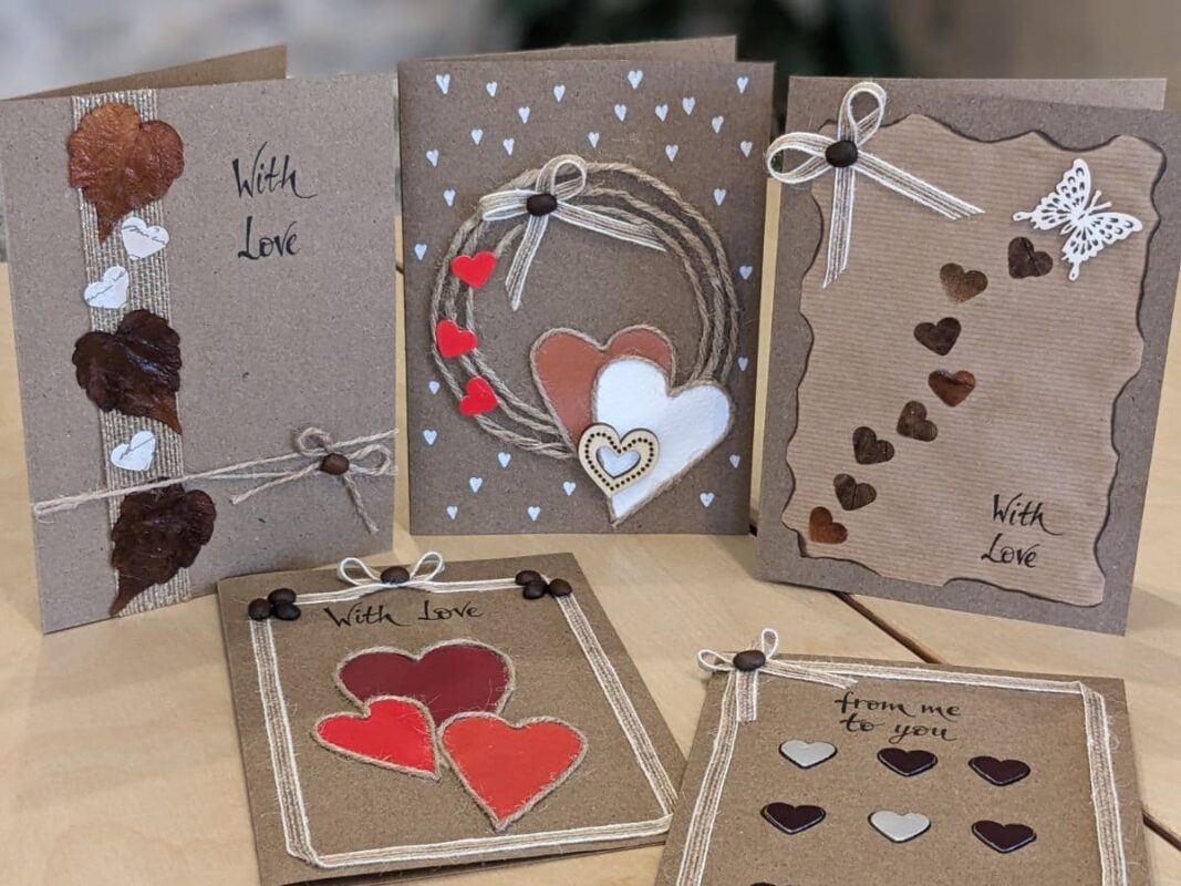 A collection of five romantic handmade Valentine’s cards UK featuring rustic kraft paper designs with heart cards, love cards with coffee bean accents, pressed autumn leaves, and romantic cards decorated with twine wreaths and butterfly cutouts.