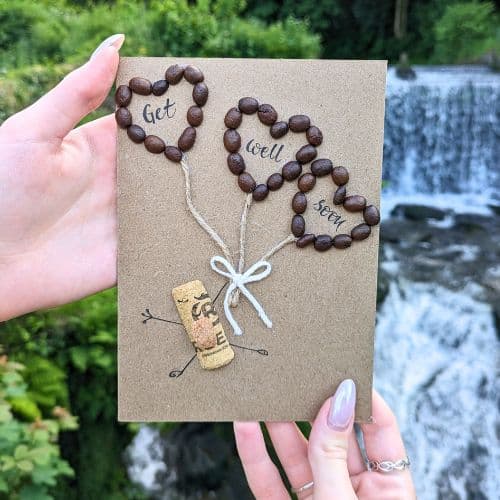 Types of greeting cards – handmade get well soon card on kraft paper with coffee bean hearts and natural twine.