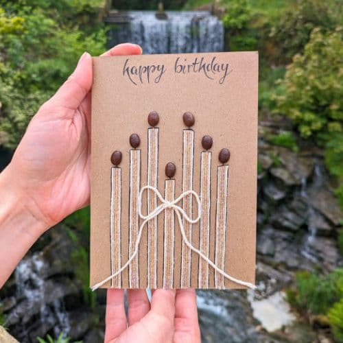 Types of greeting cards – handmade birthday card on recycled kraft paper with coffee bean candles and handwritten calligraphy.