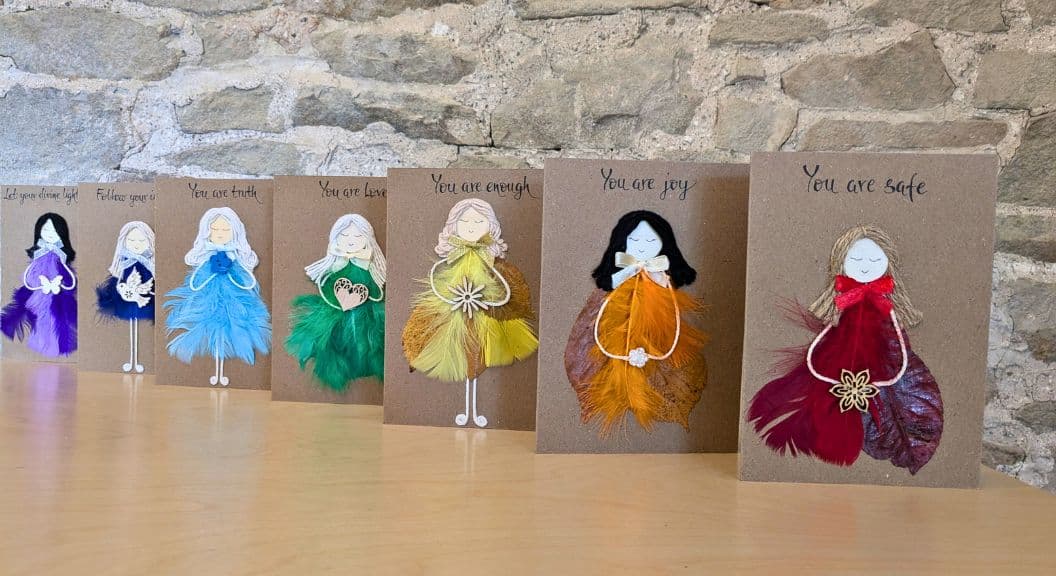 Types of greeting cards displayed as handmade cards for her, featuring affirmational designs created with feathers and natural materials.